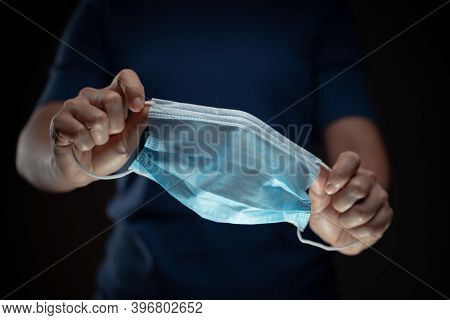 Close Up Shot Of Hands Holding Protective Face Mask.