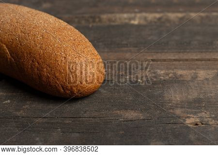Freshly Baked Traditional Black Bread On A Wooden Table. Brown Coarse Bread Made From Shenitsa, Barl
