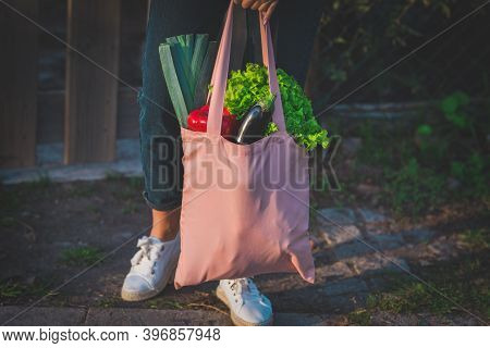 Close Up Of Pink Reusable Eco Bag With Fresh Bio Vegetables. Eggplant, Red Bell Paper And Green Lett
