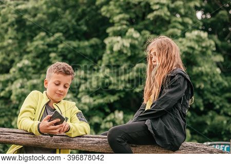 Happy Smiling Kids Having Fun While Watching Something Funny On Smart Phone