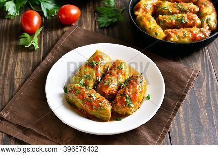 Cabbage Rolls Stuffed With Ground Beef, Rice On Plate Over Wooden Table. Close Up View