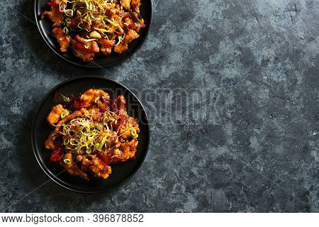 Spicy Garlic Fried Chicken (kkanpunggi). Asian Chicken In Sweet And Sour Sauce On Plate Over Dark St