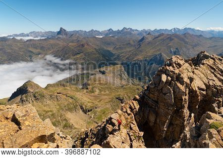 Two Anonymous Climbers Reaching Aspe Peak In The Pyrenees With Peaks And Mountains On The Spanish Si