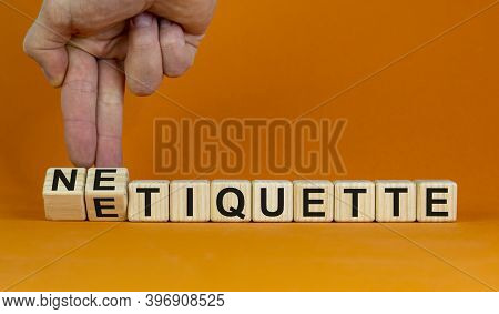 Etiquette Or Netiquette. Male Hand Turns Cubes And Changes The Word 'etiquette' To 'netiquette'. Bea