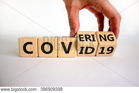 Covering Covid-19. Male Hand Turns Cubes With Words 'covering Covid19'. Covid-19 Postpandemic Concep