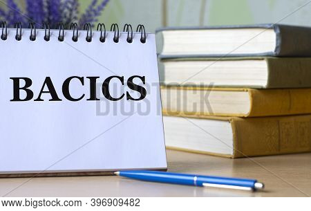 Bacics - A Word In A Notebook Against The Background Of Old  With A Pen. Education Concept.