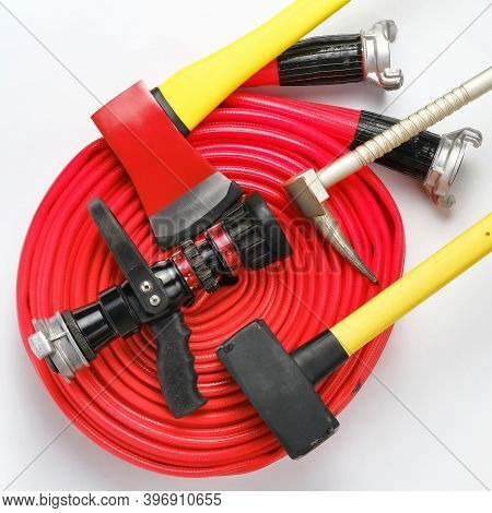 Large Yellow Sledgehammer, Axe, Hooligan Pinch-bar And Rolled Fire Hose From Firemans Toolbox On Whi