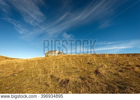 Meadow And Stone Farmhouse In Autumn On Lessinia Plateau (altopiano Della Lessinia), Regional Natura
