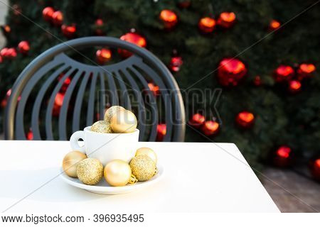 Composition With Coffee Cup, Golden Christmas Balls Inside And Around. Coffee Pair On White Table An