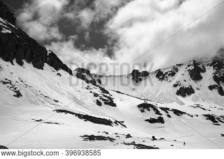 High Mountains With Snow Cornice And Avalanche Tracks, Snowy Plateau And Cloudy Sunlit Sky At Sunny 