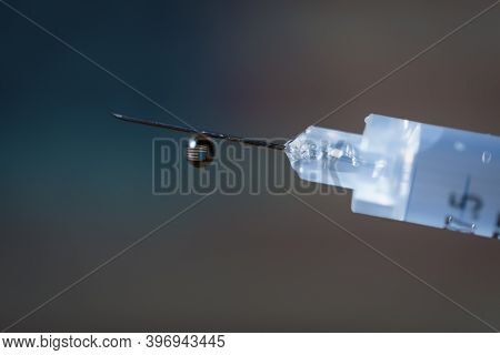 Close-up Of A Drop In A Syringe With The United States Flag Waving Inside.