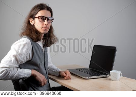 Programming And Application Development, A Young Man Writes Code Sitting At A Laptop. Training In Pr