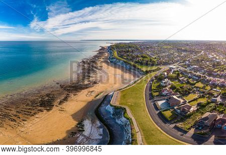 Drone aerial view of the beach and white cliffs on sunny day, Margate, England, UK