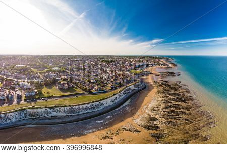 Drone aerial view of the beach and white cliffs on sunny day, Margate, England, UK