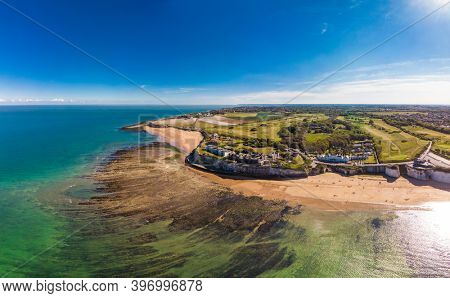 Drone aerial view of the beach and white cliffs on sunny day, Margate, England, UK