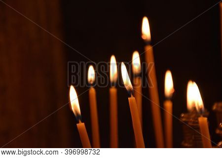 Candles In The Darkness Of An Orthodox Church In The Plaka Neighborhood Of Athens (greece)