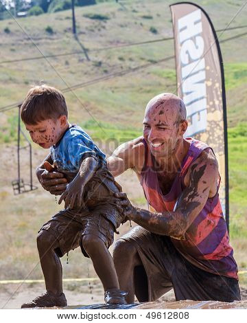 Father helping his son during the race