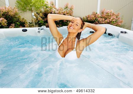 Beautiful woman relaxing in a hot tub. Vacation.