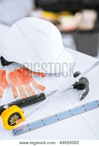 architecture and home renovation concept - blueprint, flexible ruller, helmet and hammer