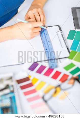 interior design and renovation concept - woman working with color samples for selection