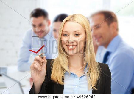 business and technology concept - businesswoman drawing checkmark on virtual screen