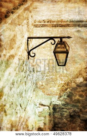 old lantern in medieval town - toned picture in retro style