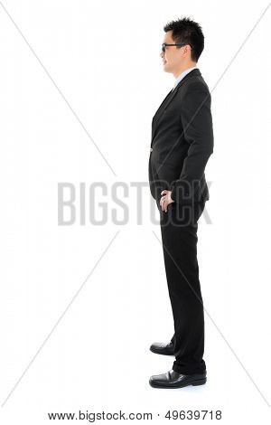 Side view full body Asian business man in formal suit standing isolated on white background