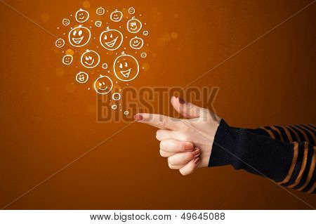 Group of happy hand drawed smiley faces coming out of gun shaped hands