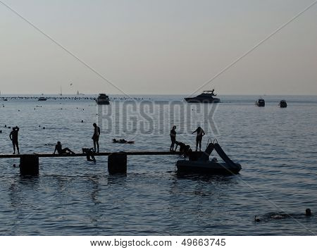 Silhuettes Of People On The Beach