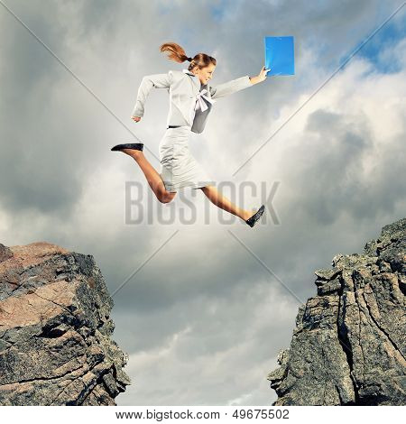 Young businesswoman jumping