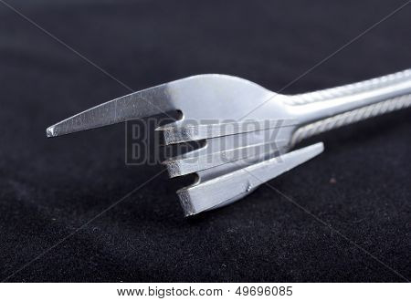 Bent metal fork.
