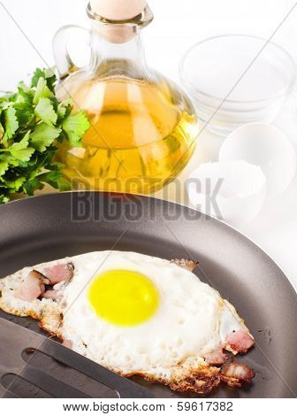 Fried eggs on a frying pan with olive oil