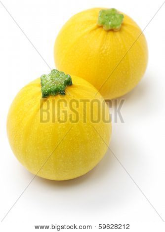 two yellow round zucchini isolated on white background