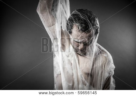 Trap.man tangled in huge white spider web