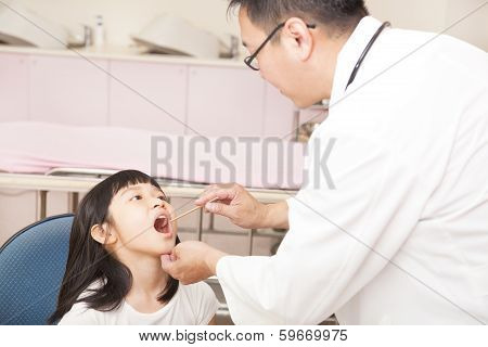 Pediatrician Examining  Kid Throat With  Tongue Depressor