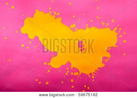 Yellow Paint Splash over Magenta Background