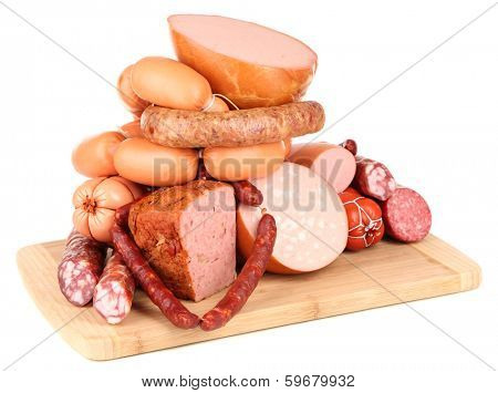 Lot of different sausages on wooden board isolated on white