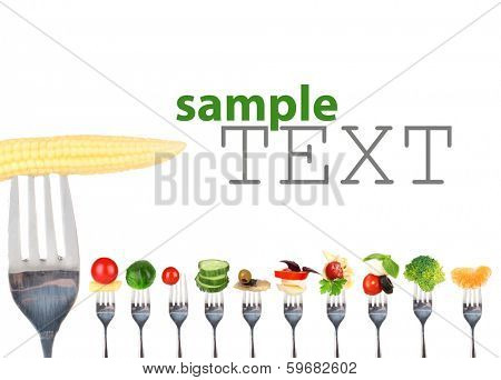 Different food on forks isolated on white