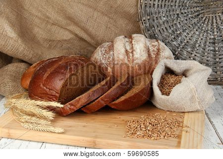 Rye bread with grains on table on sackcloth background
