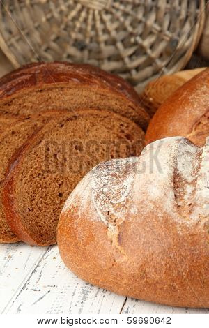 Rye bread on table on wicker background