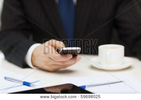 business, technology and interent concept - businessman with smartphone reading news