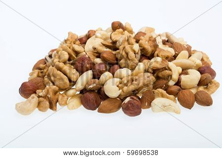 mixed nuts - hazelnuts walnuts cashews pine nuts isolated on white background