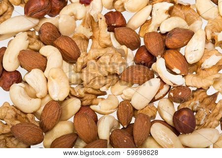 background of mixed nuts - hazelnuts walnuts cashews pine nuts