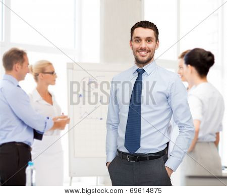 business, office and people concept - group of smiling businessmen with smartboard in office