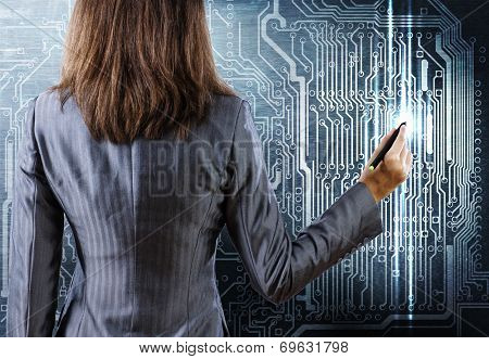 Rear view of businesswoman drawing curcuit board