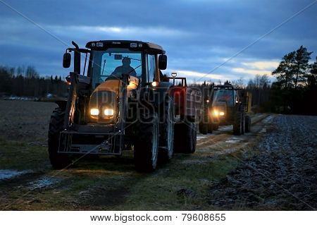 Two Agricultural Tractors On A Winter Night
