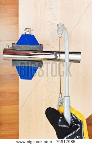 Metalworker Sawing Trap Pipe Gripped In Vice