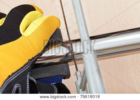 Plumber Sawing Drain Pipe Close Up
