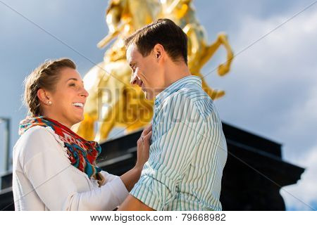 Tourist couple in Dresden in front of Goldener Reiter statue