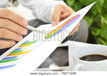 closeup of a young businessman checking some charts